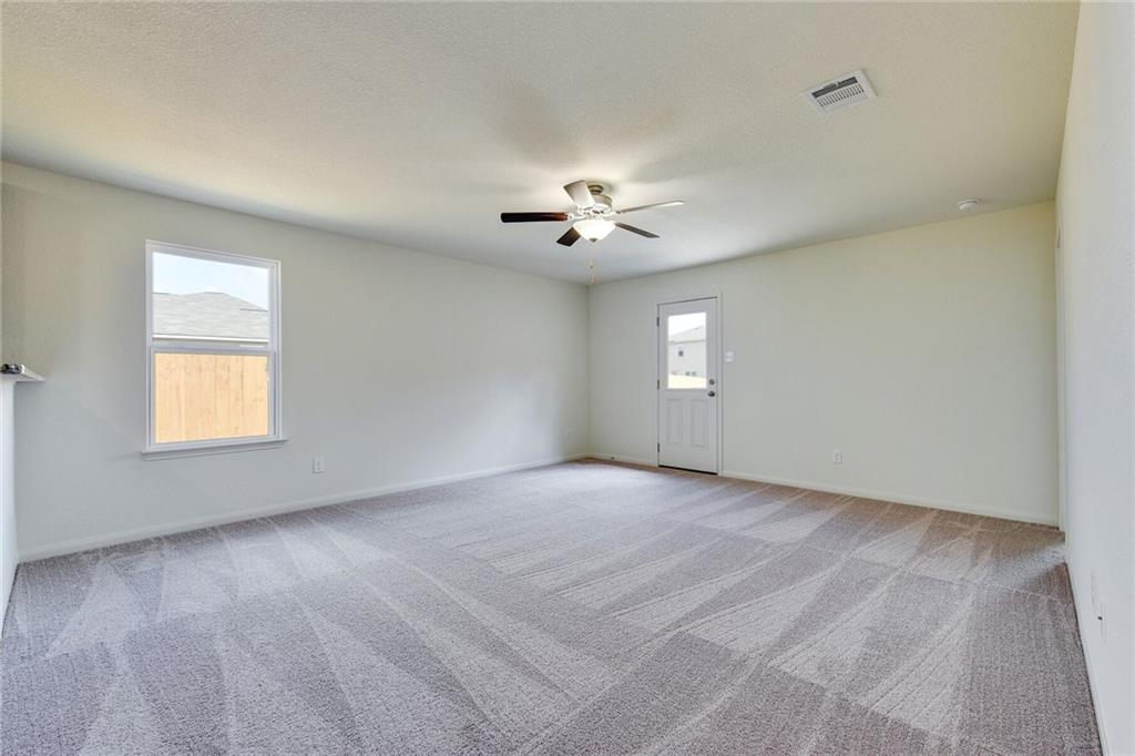 140 Allington Circle Jarrell, TX 76537 - Photo 3 of 23 Spare room with light colored carpet, healthy amount of natural light, and ceiling fan