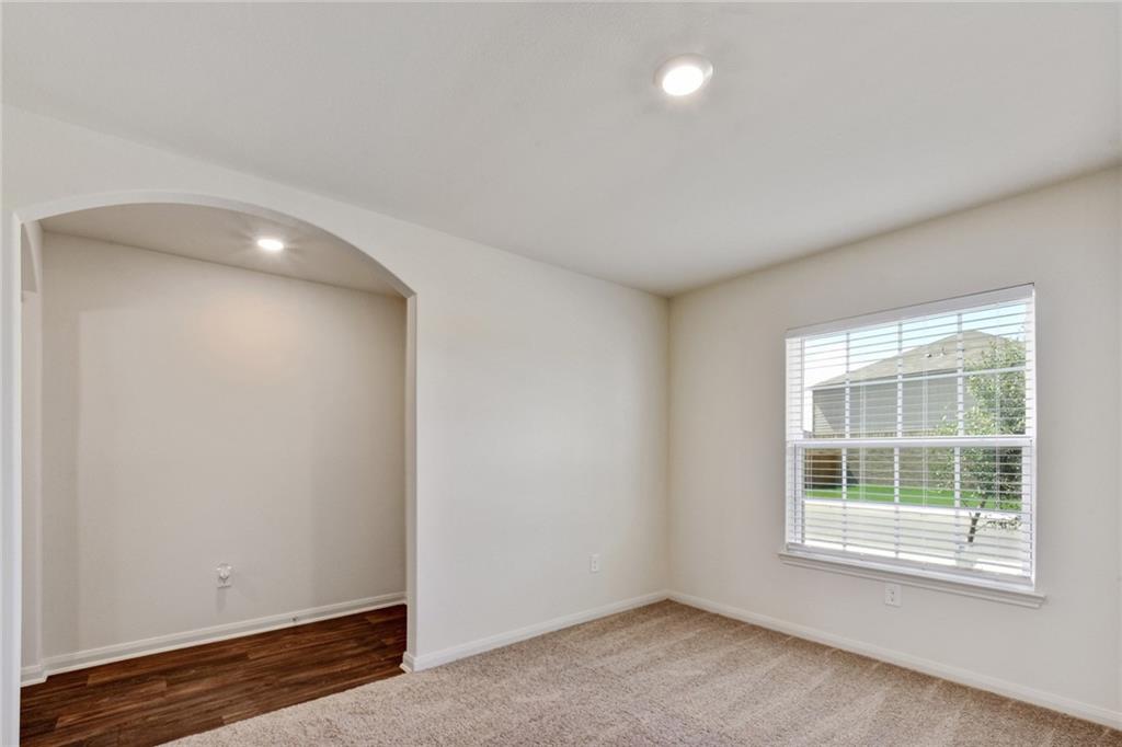 140 Allington Circle Jarrell, TX 76537 - Photo 4 of 23 Empty room with arched walkways, carpet, and recessed lighting