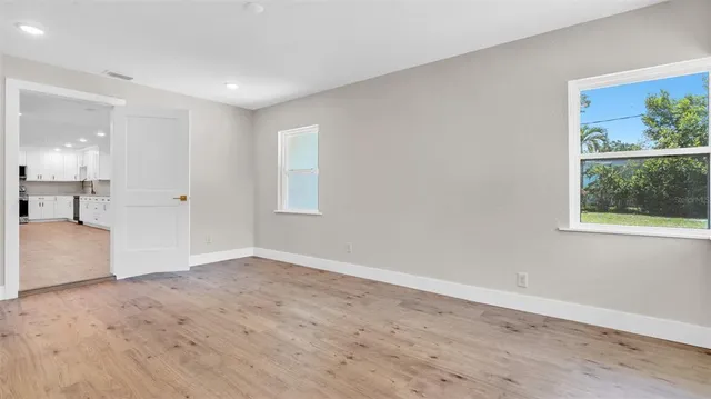 a kitchen with stainless steel appliances white cabinets white stove a microwave and a refrigerator
