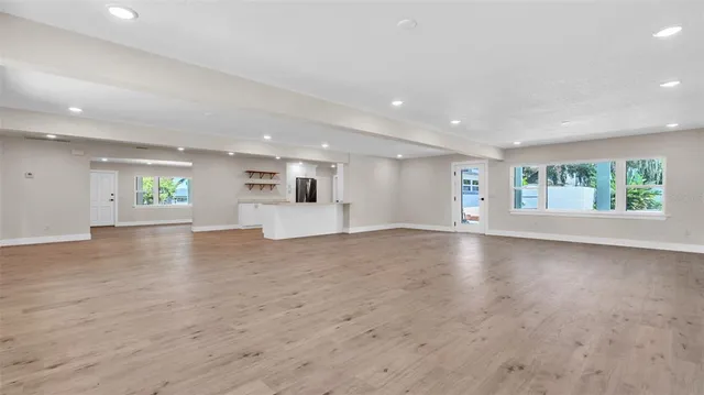 an aerial view of residential houses with outdoor space and trees all around