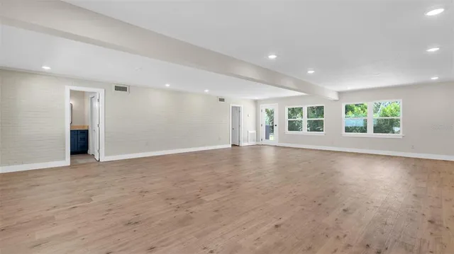 an aerial view of a houses with a yard and lake view