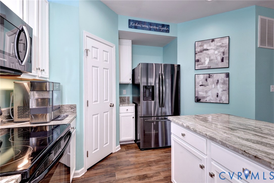8428 Sheldon Branch Place Toano, VA 23168 - Photo 13 of 46 a kitchen with stainless steel appliances a refrigerator and cabinets