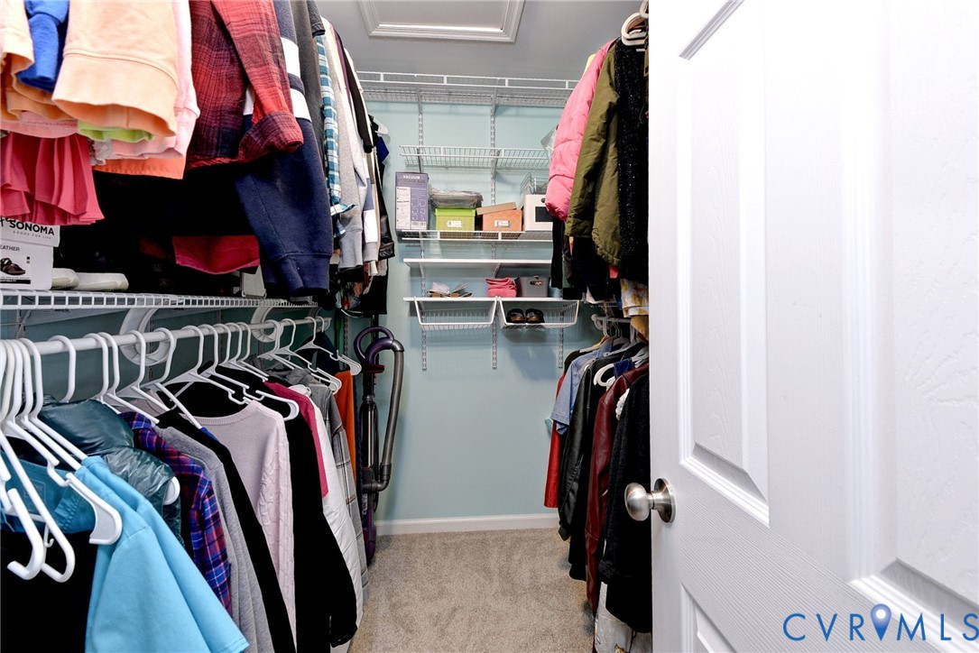 8428 Sheldon Branch Place Toano, VA 23168 - Photo 24 of 46 a view of walk in closet with clothes and shoes