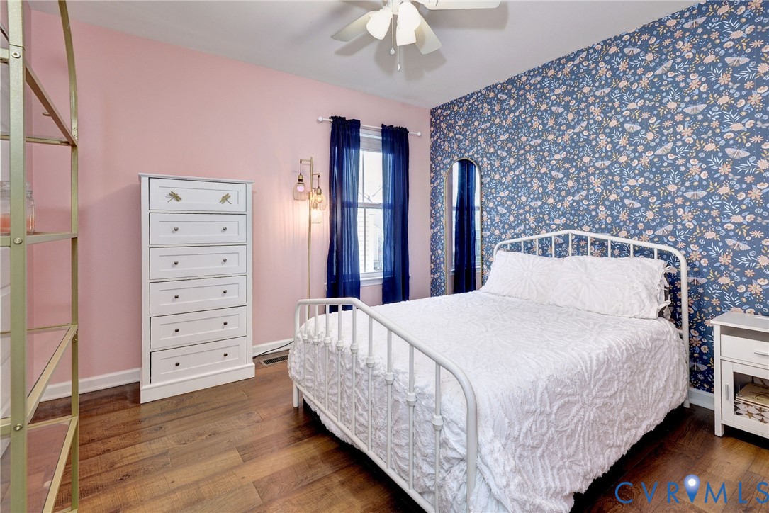 8428 Sheldon Branch Place Toano, VA 23168 - Photo 25 of 46 a bedroom with a bed and a chandelier
