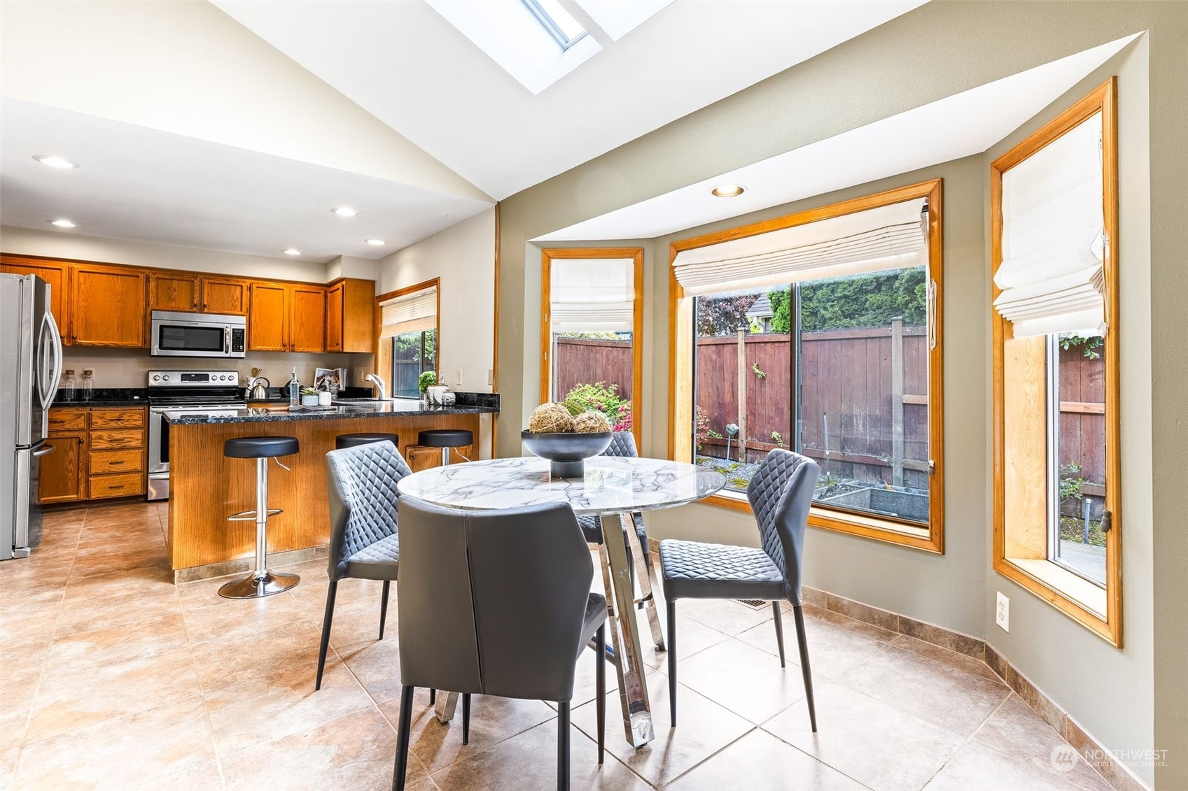 21104 33rd Drive Southeast Bothell, WA 98021 - Photo 3 of 31 a dining room with furniture a large window and a view of kitchen