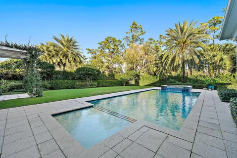 a view of house with swimming pool yard and green space