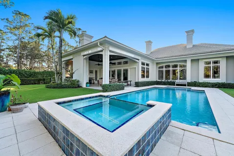 a living room with fireplace furniture and a large window