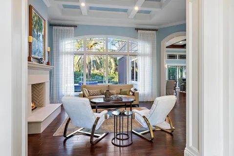 a kitchen with a stove a refrigerator and wooden floors