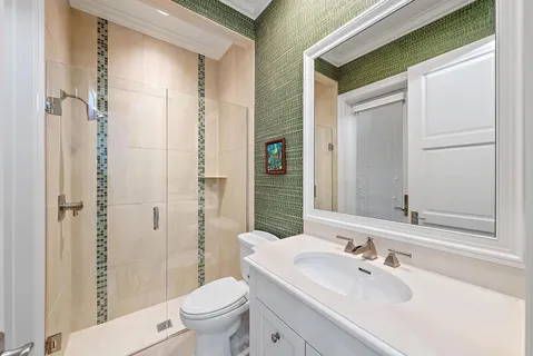 a bedroom with a bed and a computer on the desk