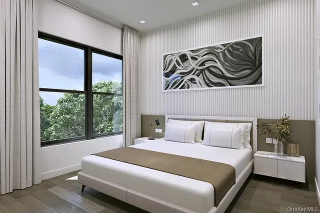 a bedroom with a bed and a large window