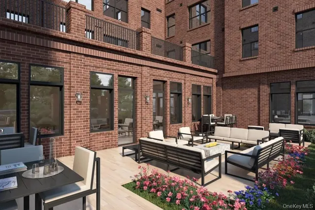 a view of a patio with couches table and chairs and potted plants