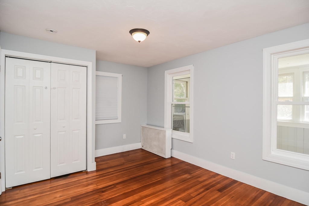 13 Crump Street Hudson, MA 01749 - Photo 12 of 33 an empty room with wooden floor and windows