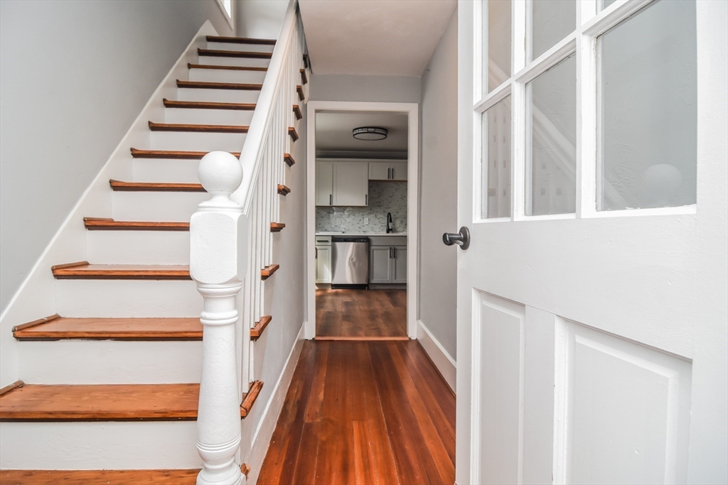 13 Crump Street Hudson, MA 01749 - Photo 18 of 33 a view of a hallway with wooden floor and staircase