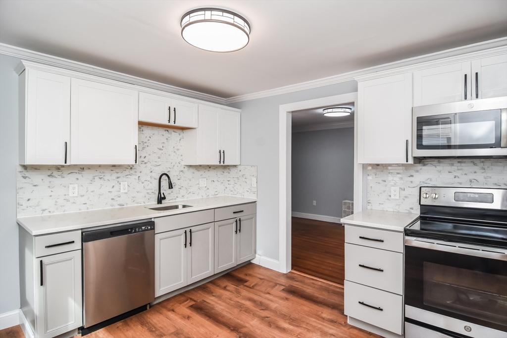 13 Crump Street Hudson, MA 01749 - Photo 2 of 33 a kitchen with stainless steel appliances granite countertop a sink and a stove