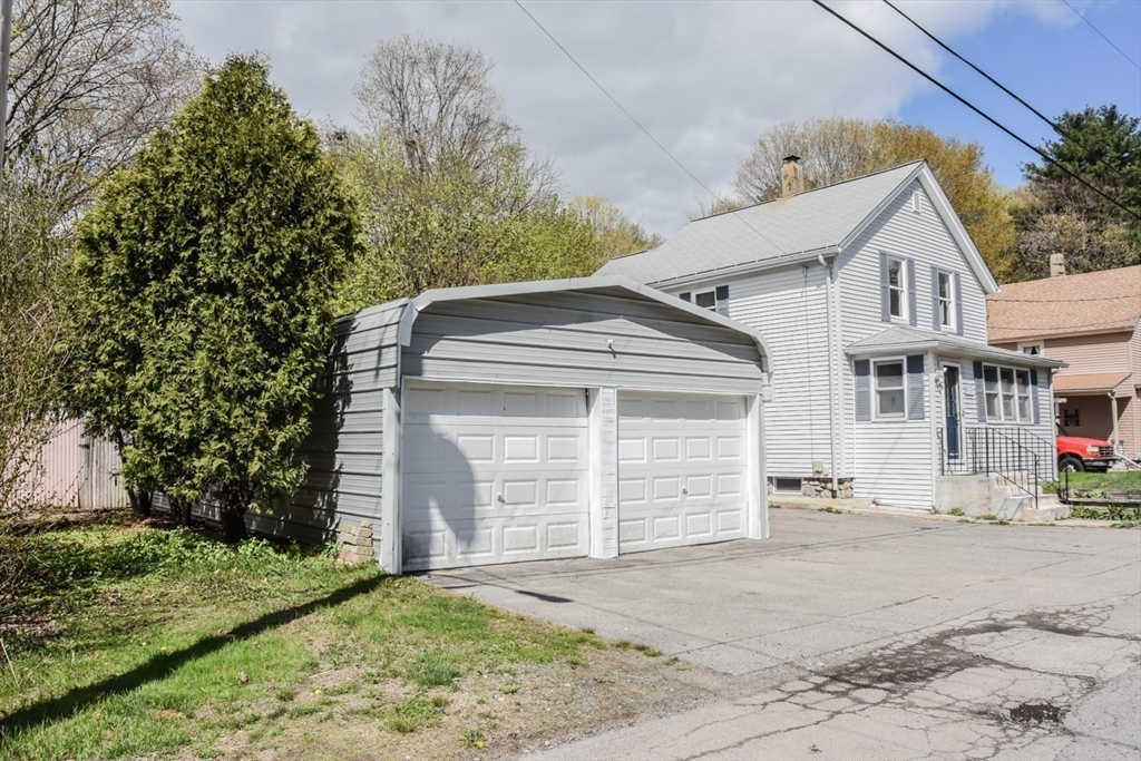 13 Crump Street Hudson, MA 01749 - Photo 29 of 33 a front view of a house with a yard and garage