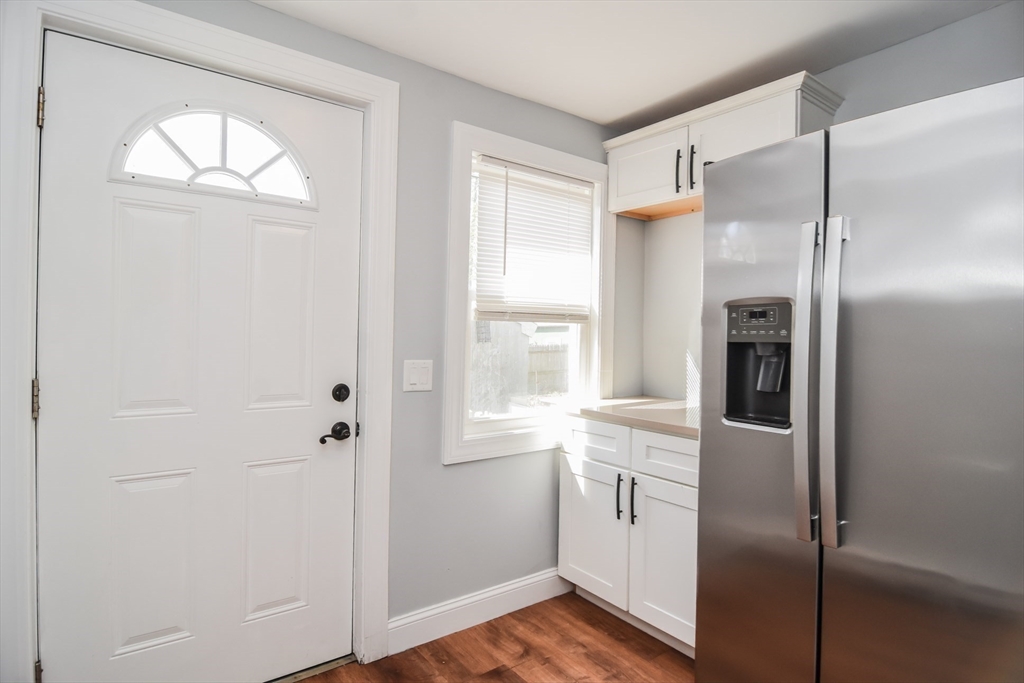 13 Crump Street Hudson, MA 01749 - Photo 7 of 33 a kitchen with a refrigerator a sink and dishwasher with wooden floor