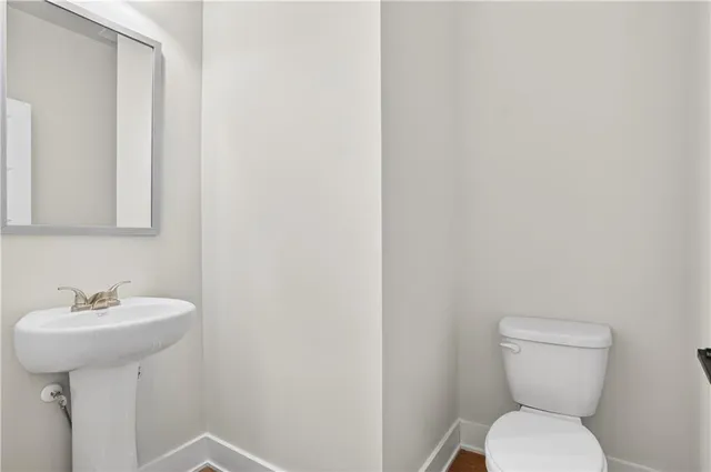 an empty room with closet and a ceiling fan