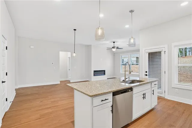 a kitchen with kitchen island sink stove and cabinets
