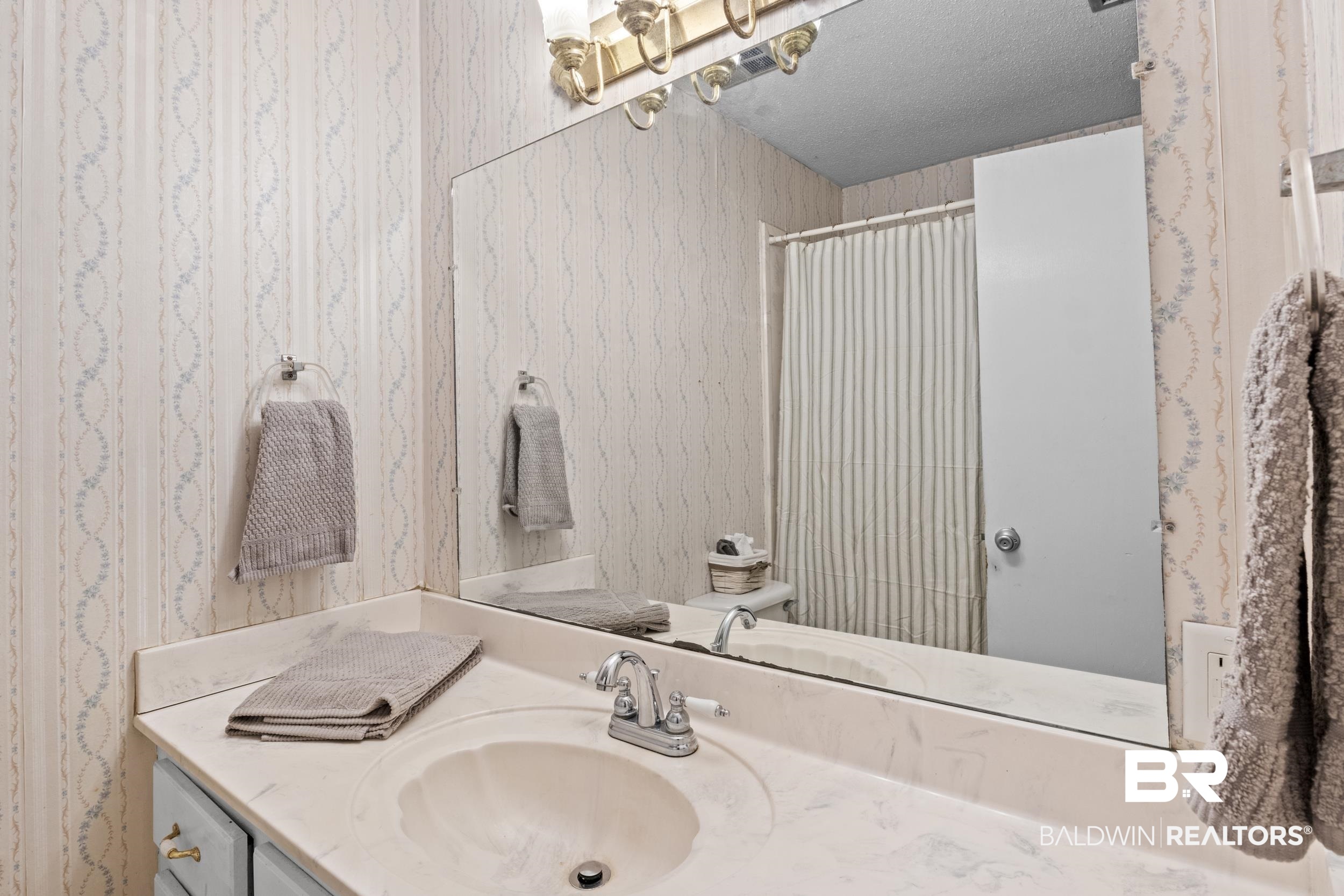 8701 A Rosemary Road Eight Mile, AL 36613 - Photo 13 of 27 Bathroom featuring a textured ceiling and vanity