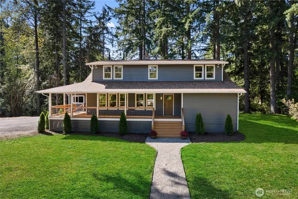 a front view of house with yard and green space