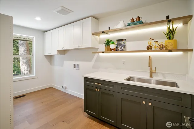 a kitchen with a sink and cabinets