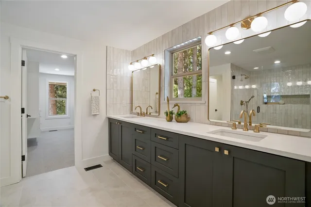 a bathroom with a double vanity sink mirror and double