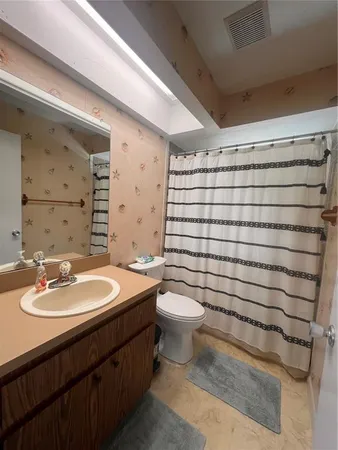 a bathroom with a sink toilet tub and shower