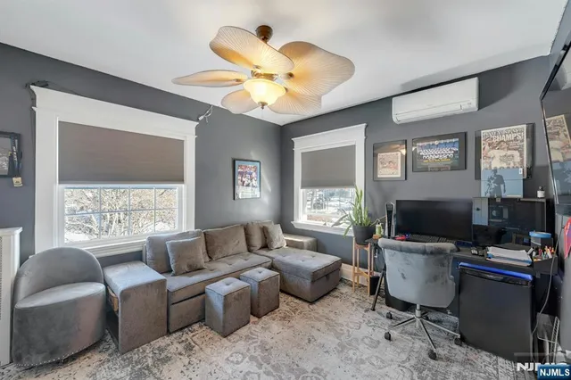 a living room with furniture a chandelier and a window