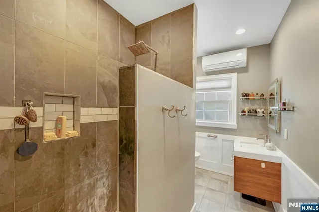 a bathroom with a bathtub and a shower