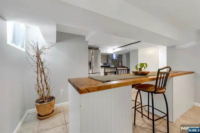 a dining room with furniture and a potted plant