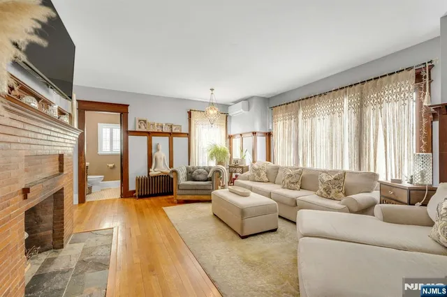a living room with furniture fireplace and a large window