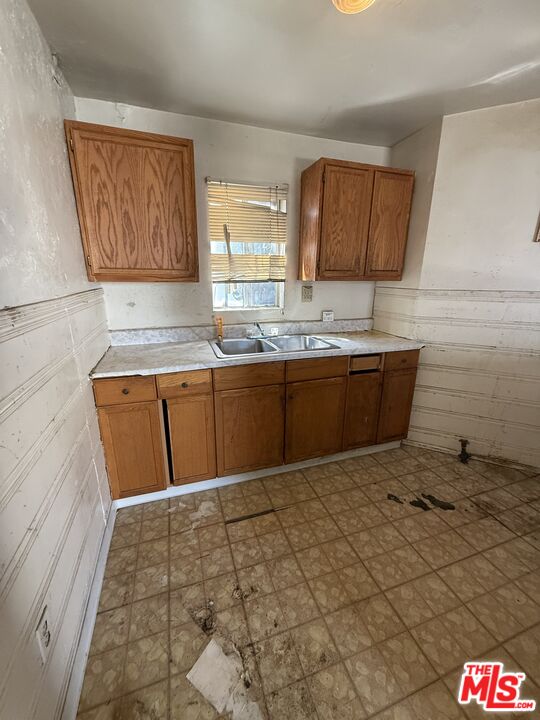 1415 North Spring Avenue Compton, CA 90221 - Photo 14 of 24 a kitchen with granite countertop a sink and a stove