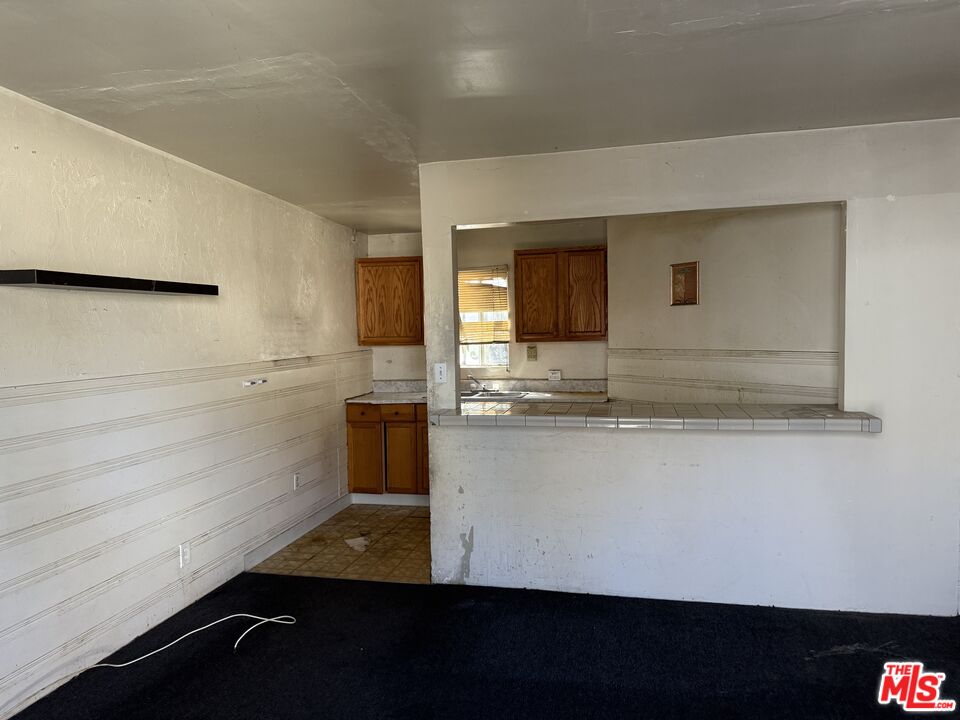 1415 North Spring Avenue Compton, CA 90221 - Photo 3 of 24 a view of kitchen cabinets and microwave