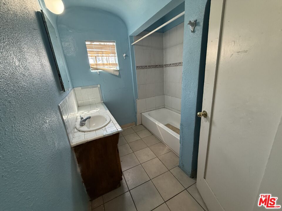 1415 North Spring Avenue Compton, CA 90221 - Photo 6 of 24 a view of bathroom with a sink and mirror