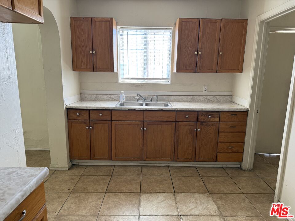 1415 North Spring Avenue Compton, CA 90221 - Photo 10 of 24 a kitchen with a sink and a refrigerator