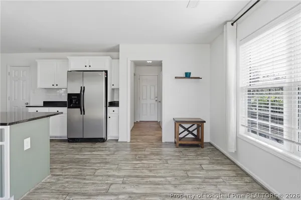 a kitchen with stainless steel appliances granite countertop a refrigerator and a stove