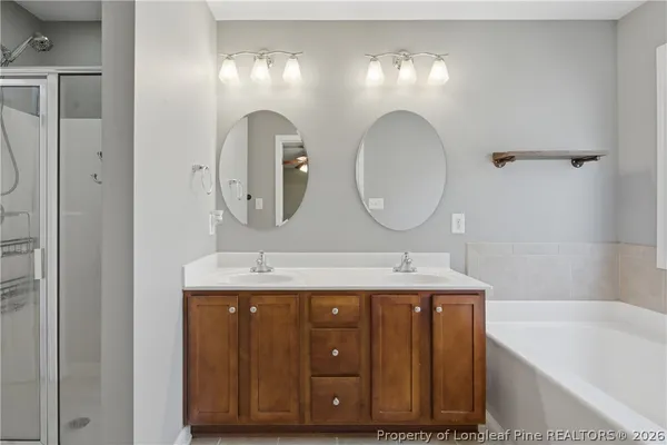 a bathroom with a double vanity sink and a mirror