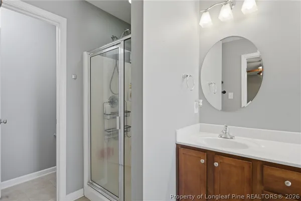 a bathroom with a double vanity sink mirror and shower