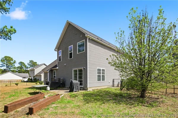 a view of a house with a yard and lawn chairs