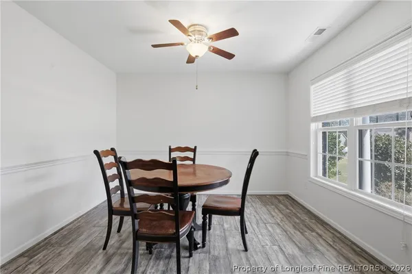 a view of a dining room with furniture and a large window