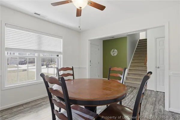 a view of a dining room with furniture window and wooden floor