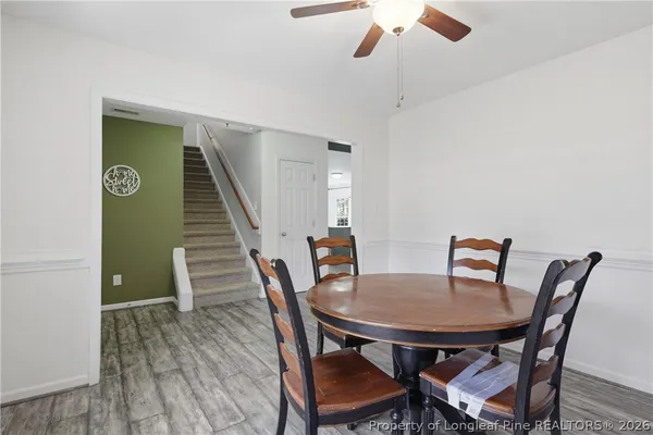 a view of a dining room with furniture and wooden floor