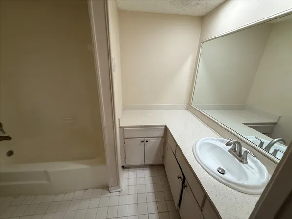 a bathroom with a sink a toilet and tub