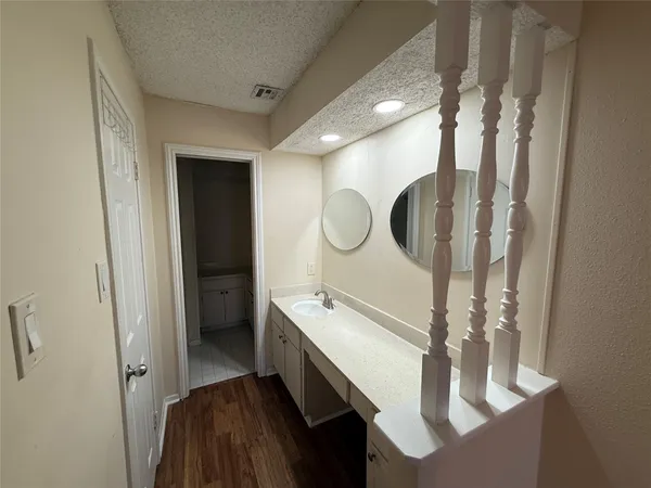a bathroom with a double vanity sink mirror and bathtub