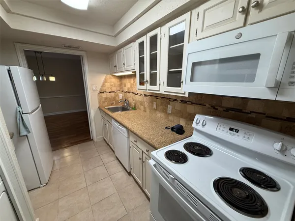 a kitchen with a stove and a microwave
