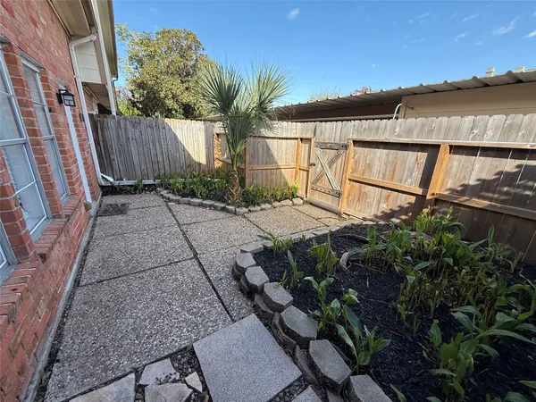 a backyard of a house with lake view and outdoor seating