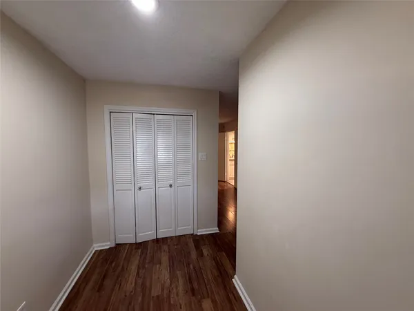 a view of a room with wooden floor and a sink