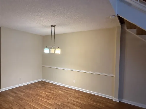 a view of a room with wooden floor fan and window