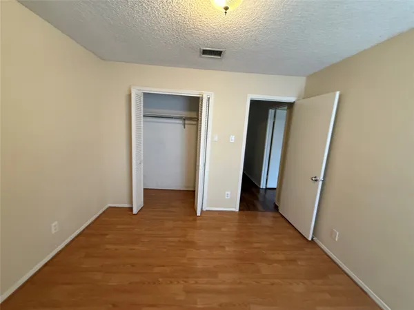 an empty room with closet and bathroom