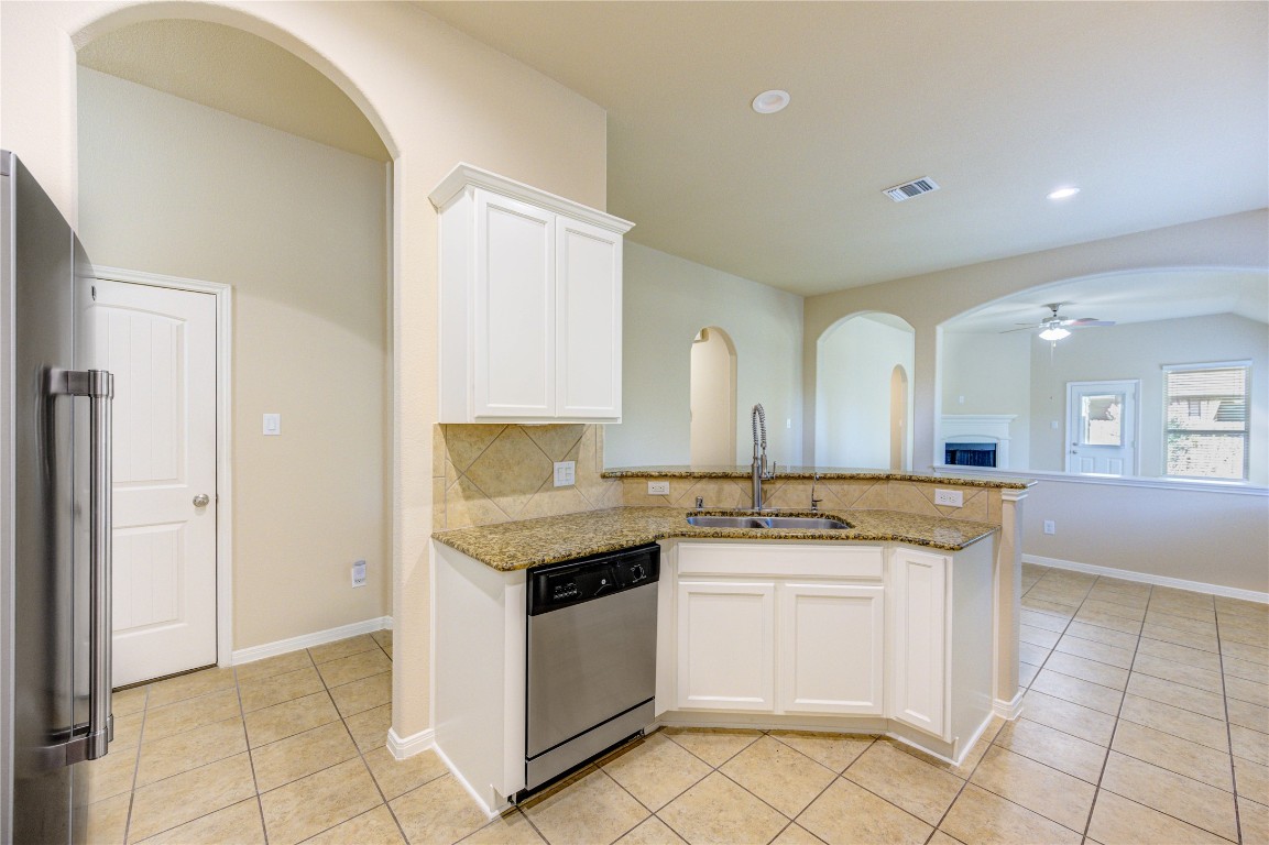 19306 Boulder Bay Lane Humble, TX 77346 - Photo 12 of 46 a kitchen with granite countertop white cabinets and white appliances